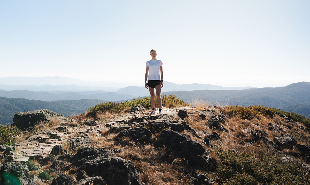 Running coach guiding athlete through strength training